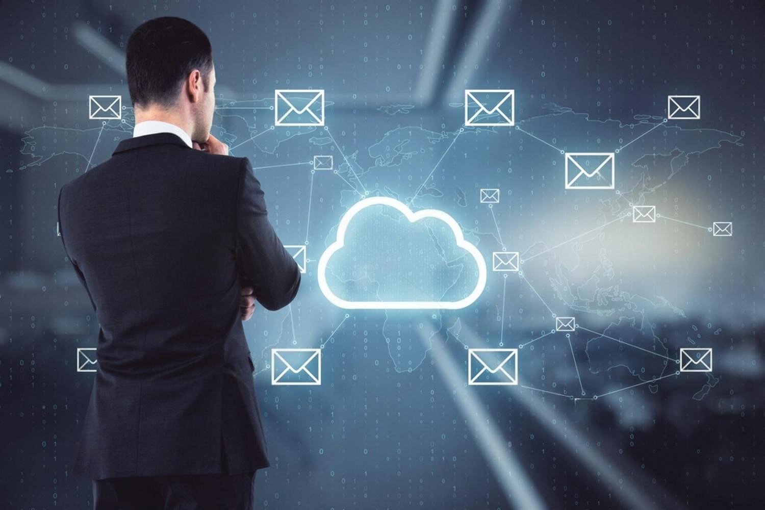 Man viewing a cloud email network on a world map, representing hosted business email across the GCC