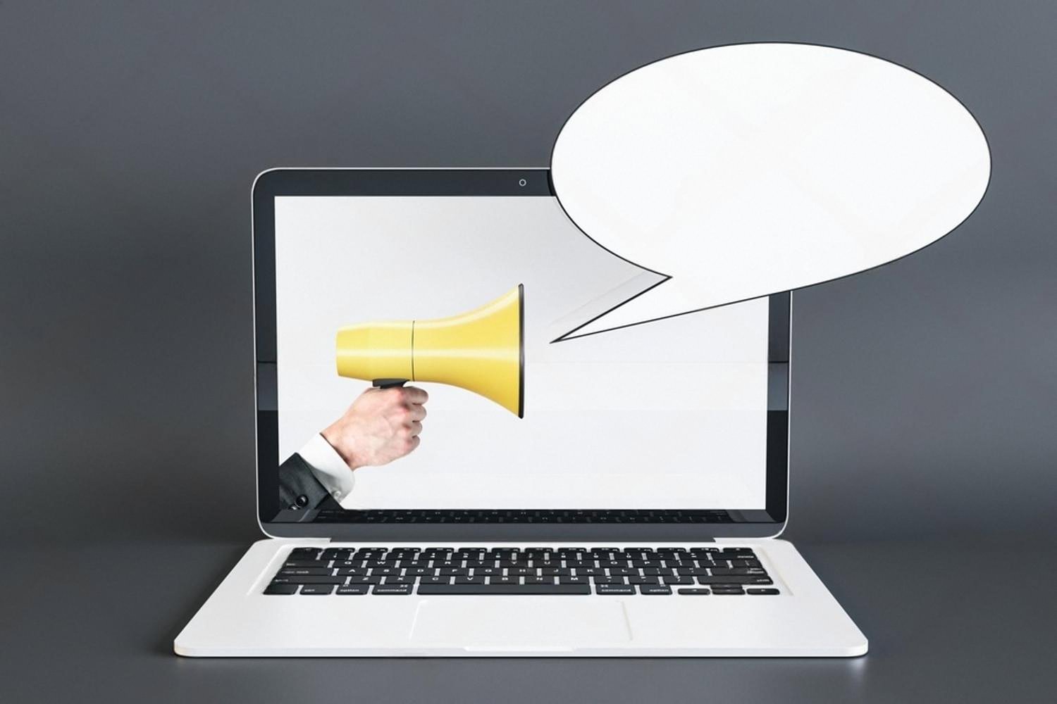 Laptop with a megaphone and speech bubble, representing brand voice and professional email communication